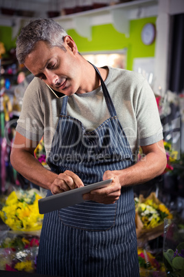 Male florist taking order on mobile phone