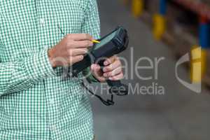 Close up of worker is using a electronic tool