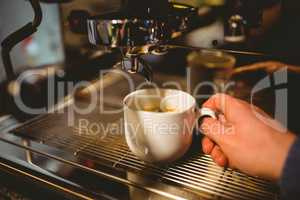 Waiter making a cup of coffee