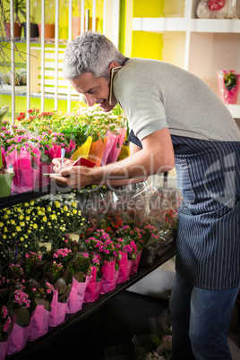 Male florist taking order on mobile phone