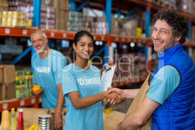 Portrait of happy volunteers handshaking
