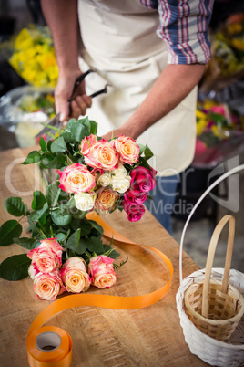 Male florist preparing bouquet of flower