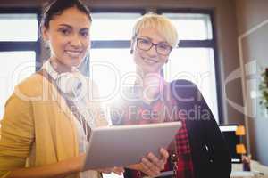 Portrait of female graphic designer using digital tablet