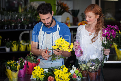 Couple preparing flower bouquet