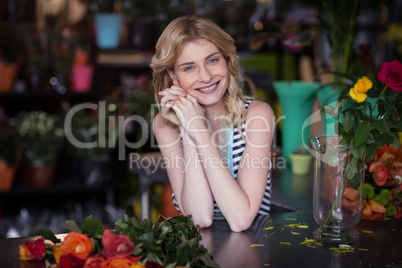 Happy female florist leaning in flower shop Happy female florist leaning in flower shop