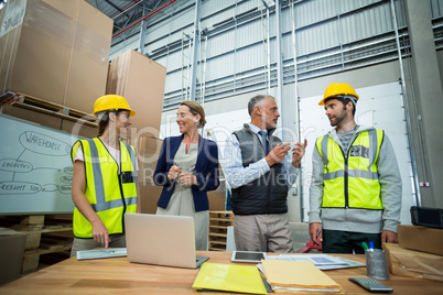 Warehouse team working on laptop and digital tablet