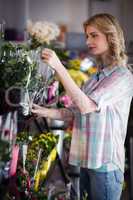 Female florist preparing a flower bouquet