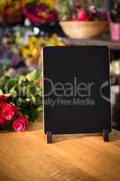Bunch of roses and digital tablet on the wooden table