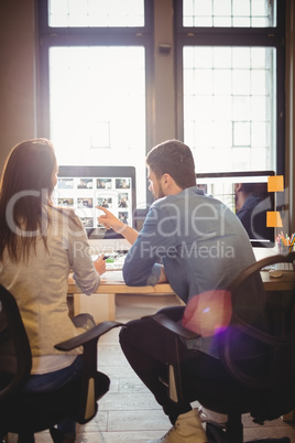 Graphic designers working at desk in the office