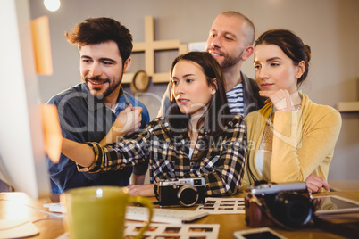 Team of graphic designers working on a computer