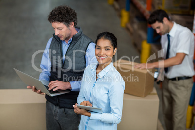 Focus of happy manager is smiling and looking the camera during