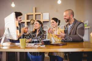 Team of graphic designers applauding a colleague