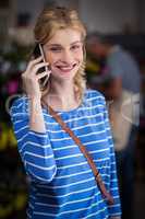 Smiling woman talking on mobile phone