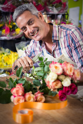 Male florist preparing bouquet of flower