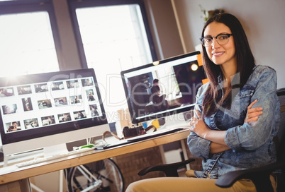 Happy graphic designer sitting at office