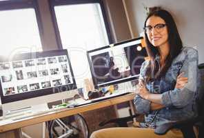 Happy graphic designer sitting at office