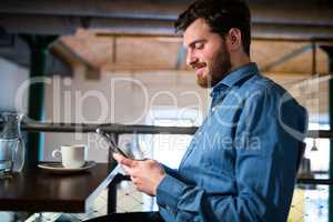 Man text messaging on mobile phone