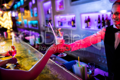 Waitress serving cocktail