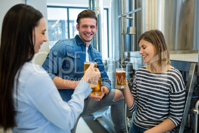 Brewers having beer at brewery