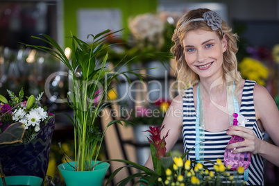 Female florist holding spray bottle