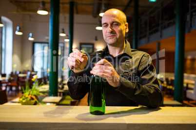 Waiter opening a bottle of white wine