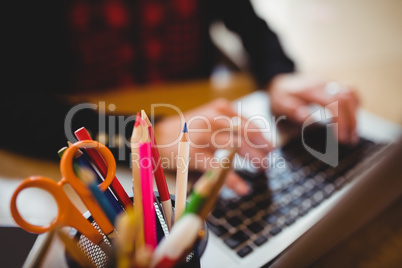 Color pencils and scissor in pen holder