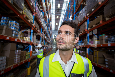 Worker in warehouse looking up