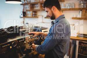 Man taking coffee from espresso machine