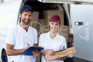 Portrait of delivery people are holding goods and smiling to the