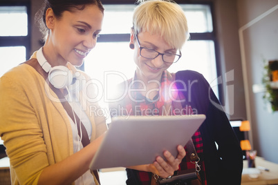 Two female graphics designer using digital tablet