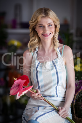 Female florist holding flowers in flower shop