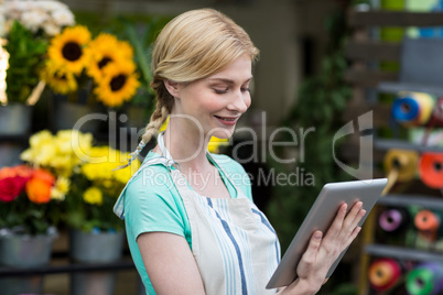 Female florist using digital tablet in florist shop