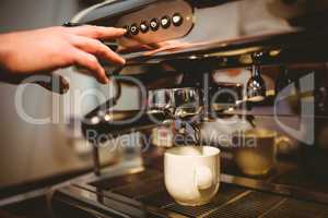 Waiter making a cup of coffee