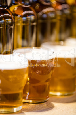 Close-up of beer glasses on the bar counter