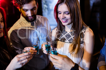 Group of friends toasting tequila shot glasses