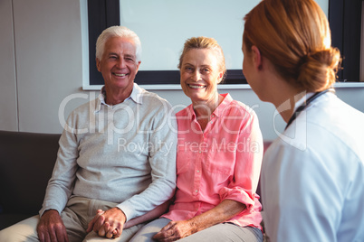 Nurse talking to senior couple