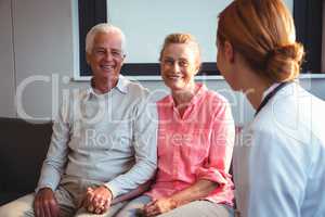 Nurse talking to senior couple