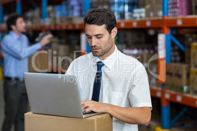 Standing business man working on computer