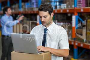 Standing business man working on computer