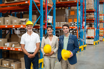 Portrait of managers are holding hard hat and posing