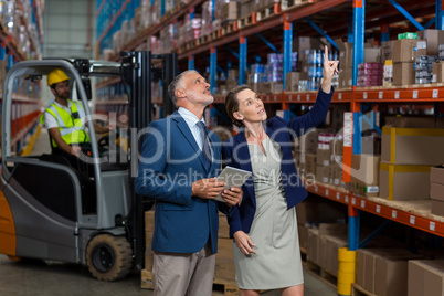 Managers are looking shelves and pointing