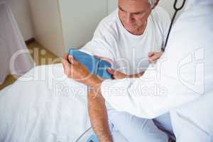 Nurse measuring the blood pressure of a senior man