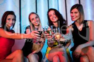 Group of smiling friends toasting glass of champagne