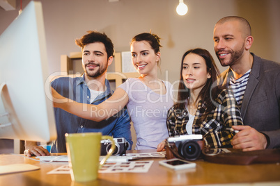 Team of graphic designers working on a computer