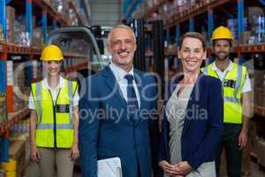 Happy managers are posing in front of the workers