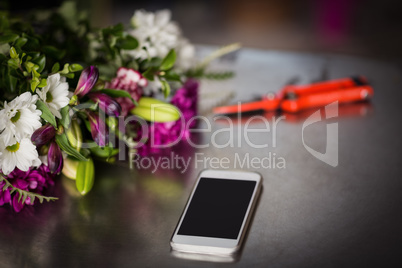 Flowers and smartphone on the table