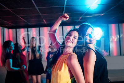 Smiling friends dancing on dance floor