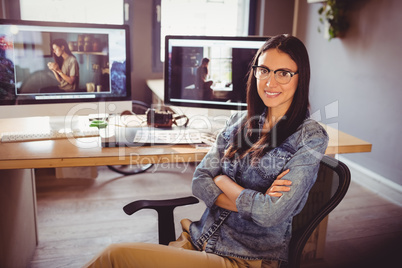 Happy graphic designer sitting at office