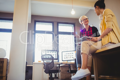 Female graphic designer using digital tablet