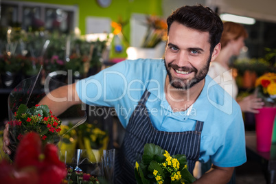 Male florist arranging flower bouquet